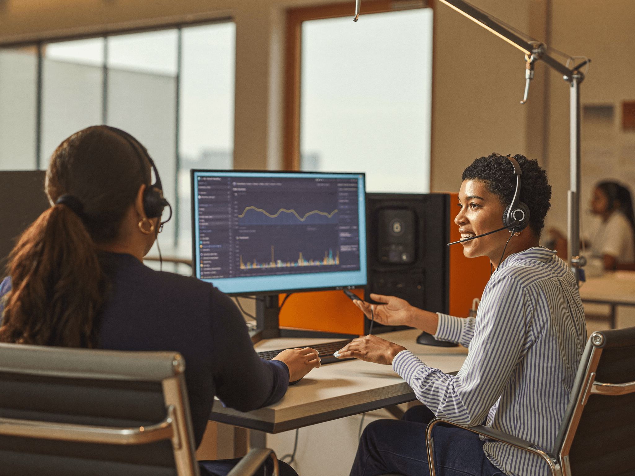 An IQAS coach and agent reviewing a call together